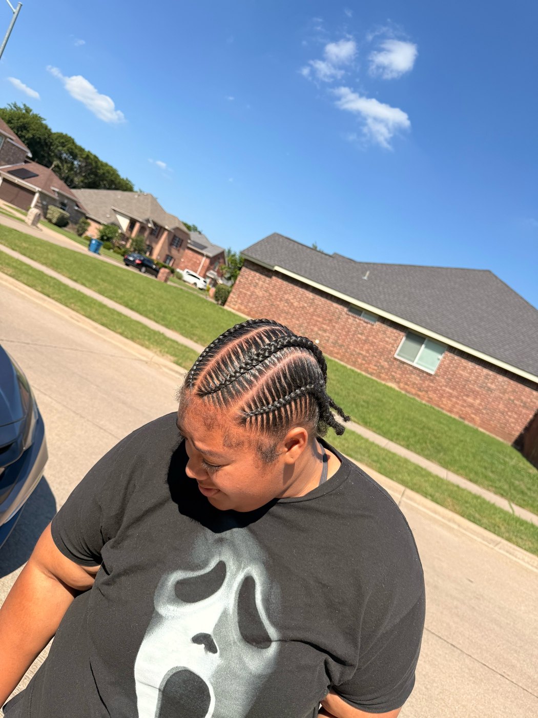 Men's braids photographed outdoors, the parting pattern in daylight